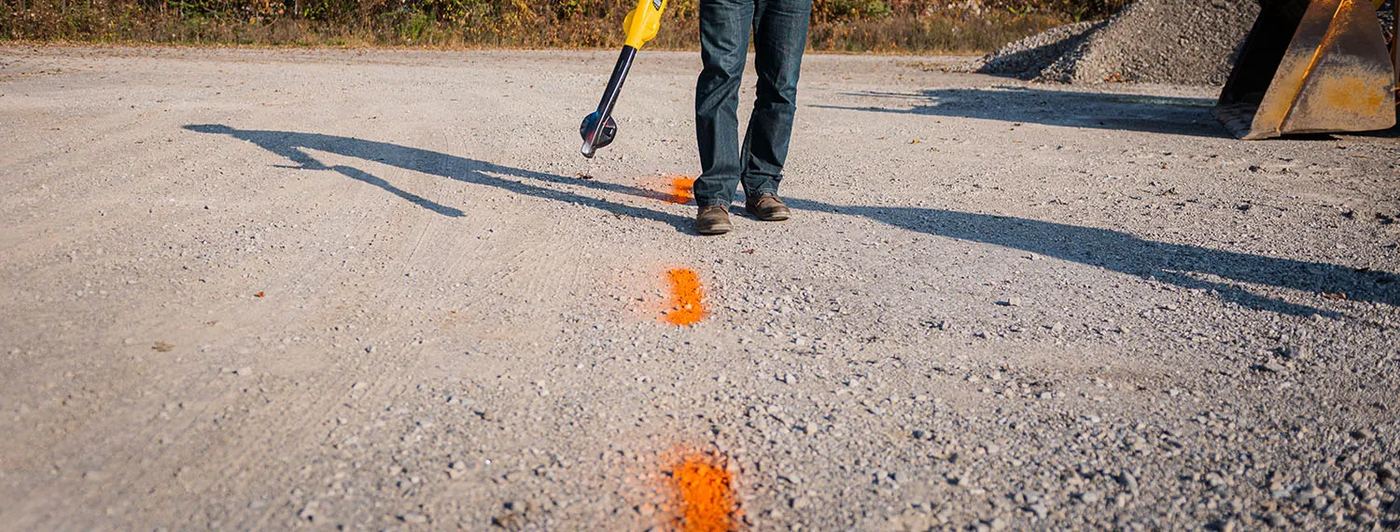 Orange paint marks on a gravel site