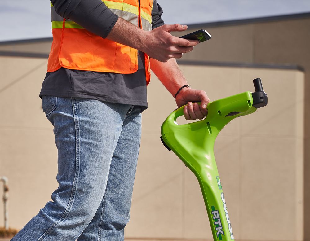 Locator in hand on a commercial lot