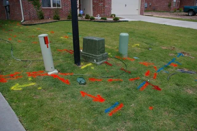 Color coded marks across a front lawn