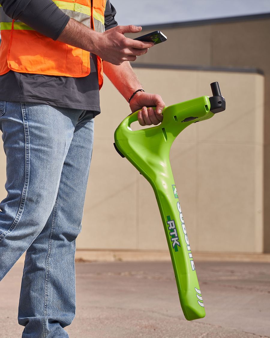 Utility locator tracing lines with a phone and locator